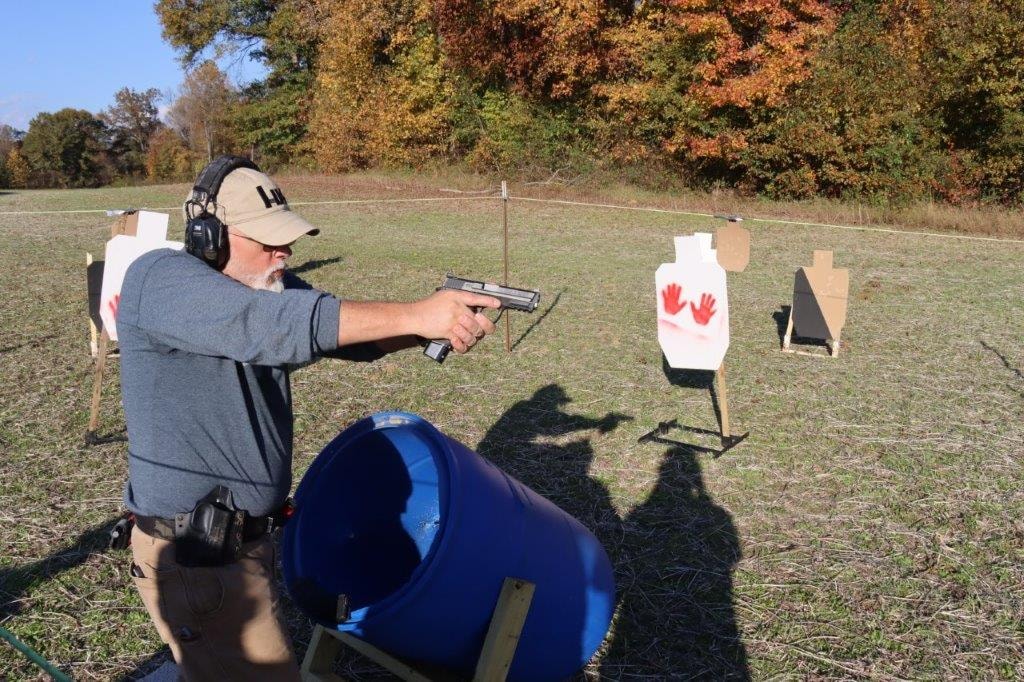 Competitor practicing with a handgun at an outdoor range